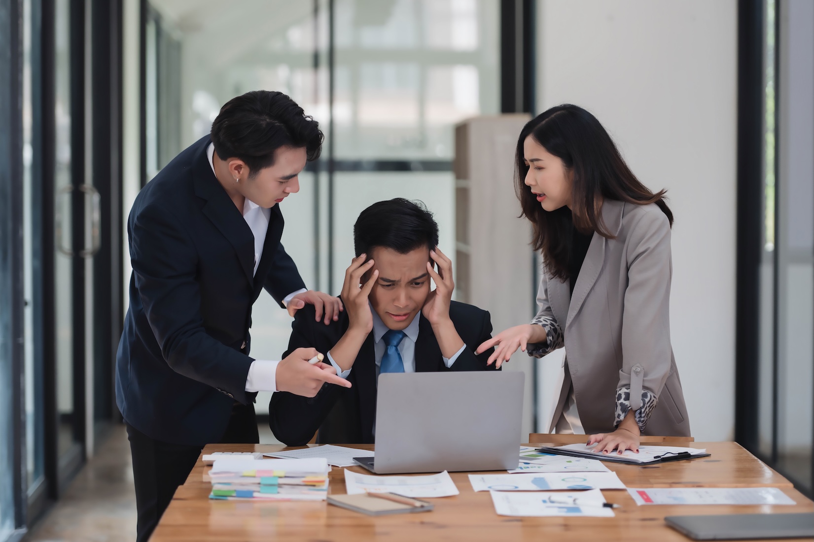 Serious mature Asian male ceo executive manager with business partners discussing corporation business plan.